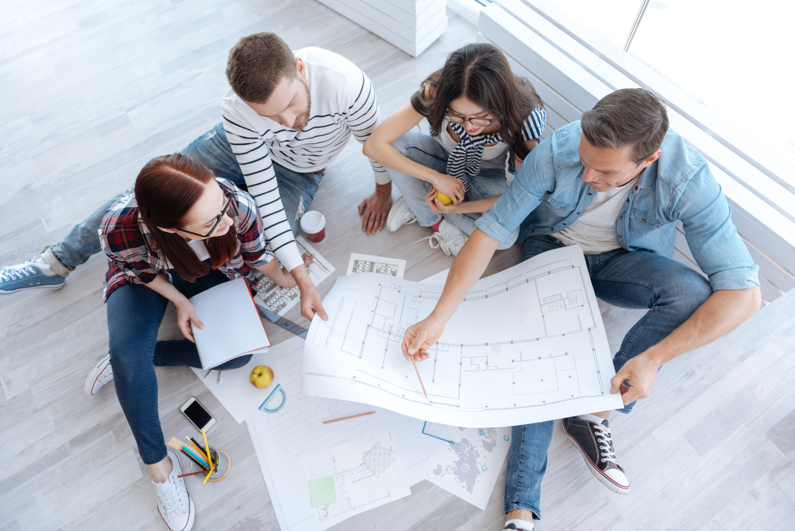 Top View Of Hard Working Architects Looking At The Blueprint Arc Top View Of Hard Working Architects Looking At The Blueprint Arc