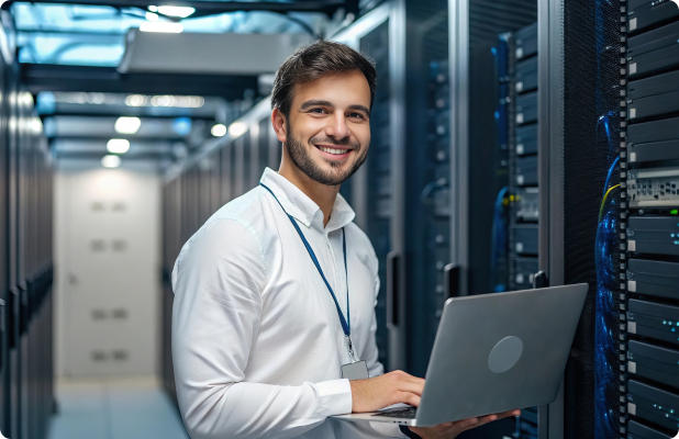 Professional in server room with laptop, surrounded by server racks with blinking lights