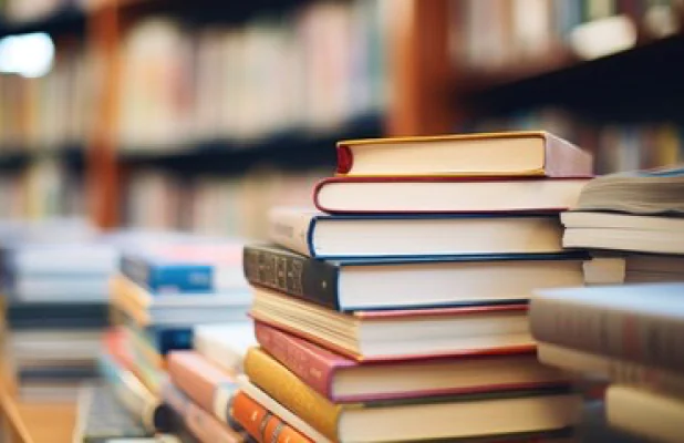 Professional in server room with laptop, surrounded by server racks with blinking lights